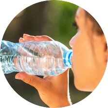 Eine Frau trinkt Wasser aus einer Flasche